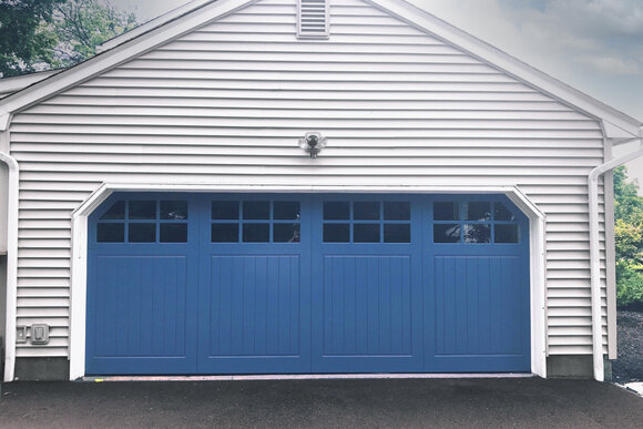 Blue garage door with colonial cut corners